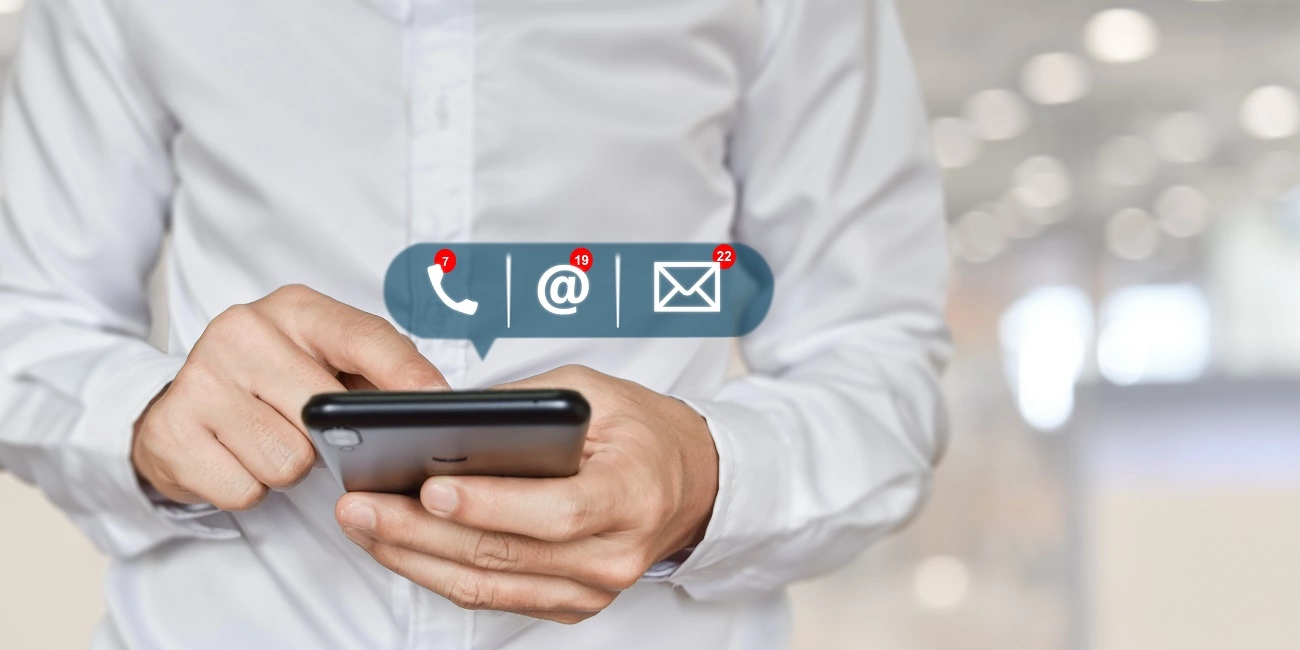 Businessman holding mobile phone with contact information